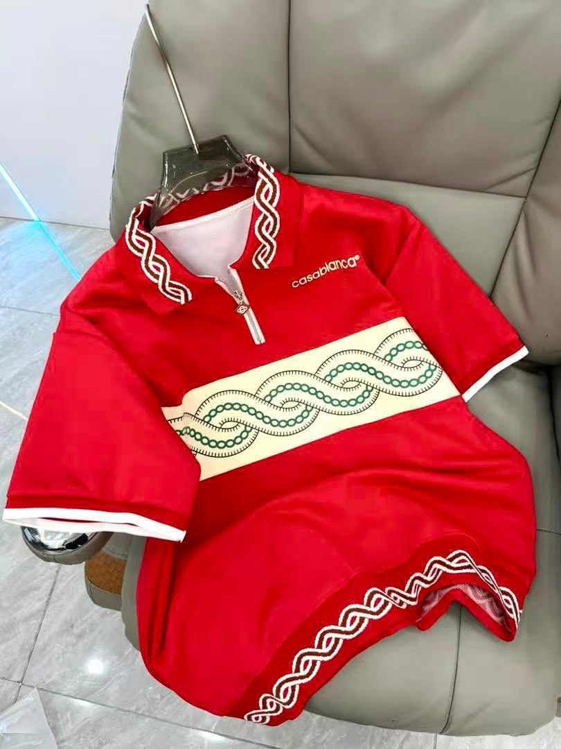 Red Casablanca polo shirt with white trim and green chain embroidery.