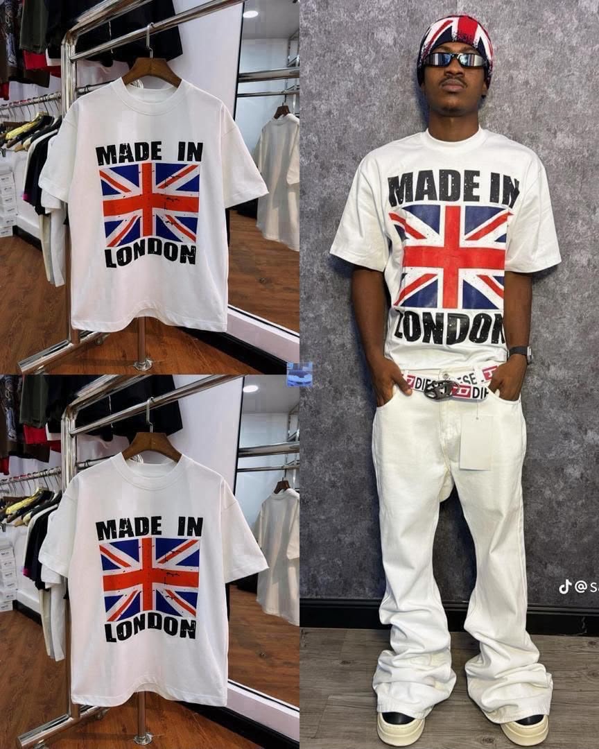 White round neck t-shirt with Made In London Union Jack graphic, shown in flat lay on hanger and worn by model with white pants.