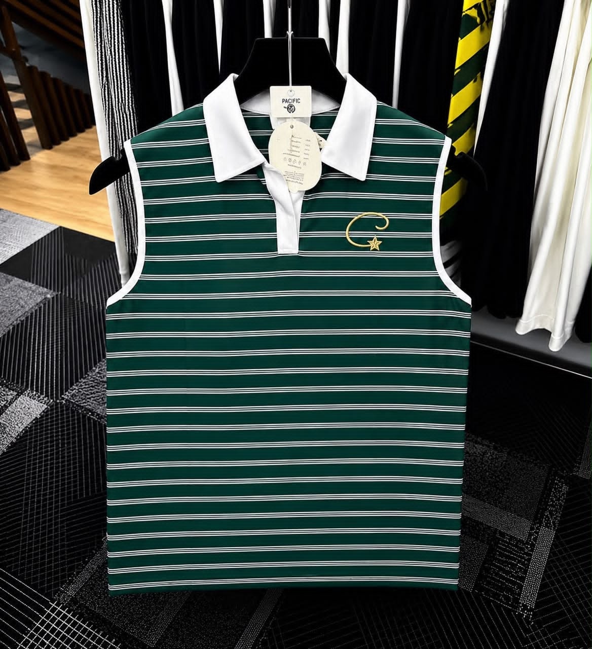 Green striped sleeveless polo top with white collar and gold embroidered logo.