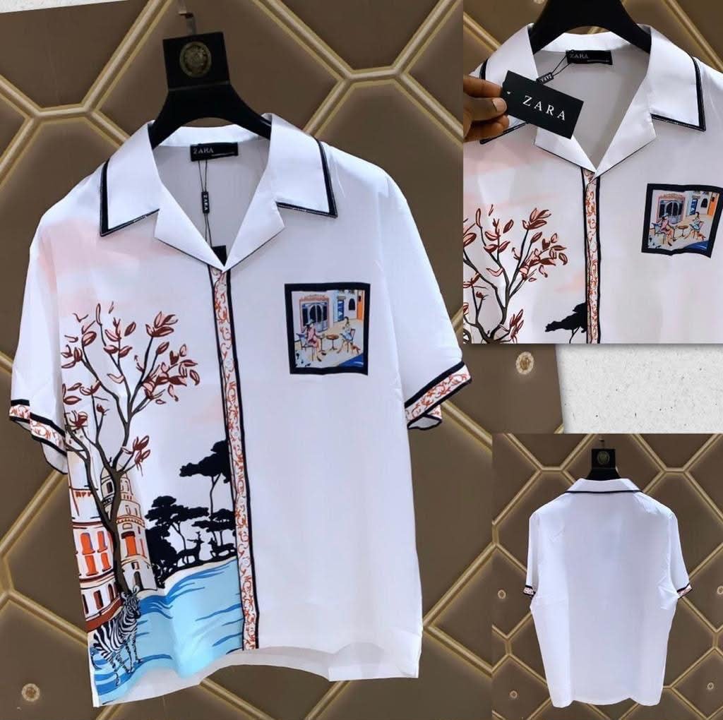 White short sleeve shirt with colorful scenic print of trees buildings and zebra shown from multiple angles.