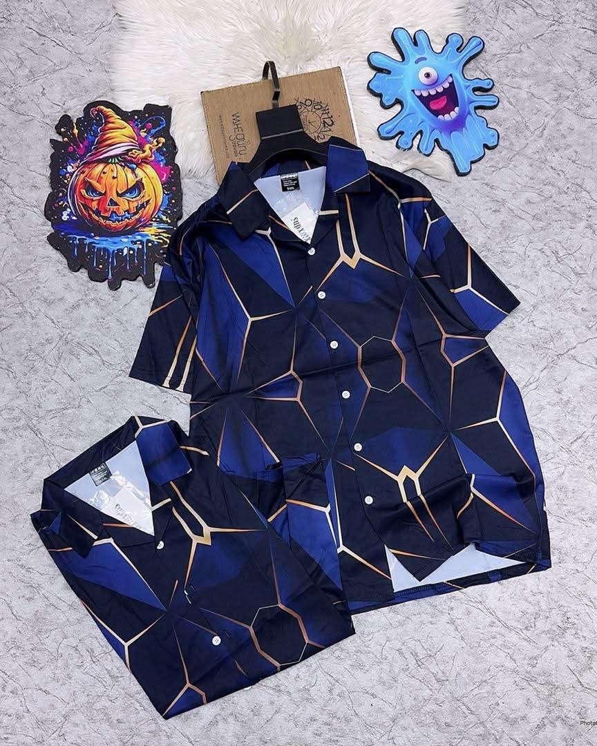 Short sleeve button-up shirt with blue black and gold geometric pattern.