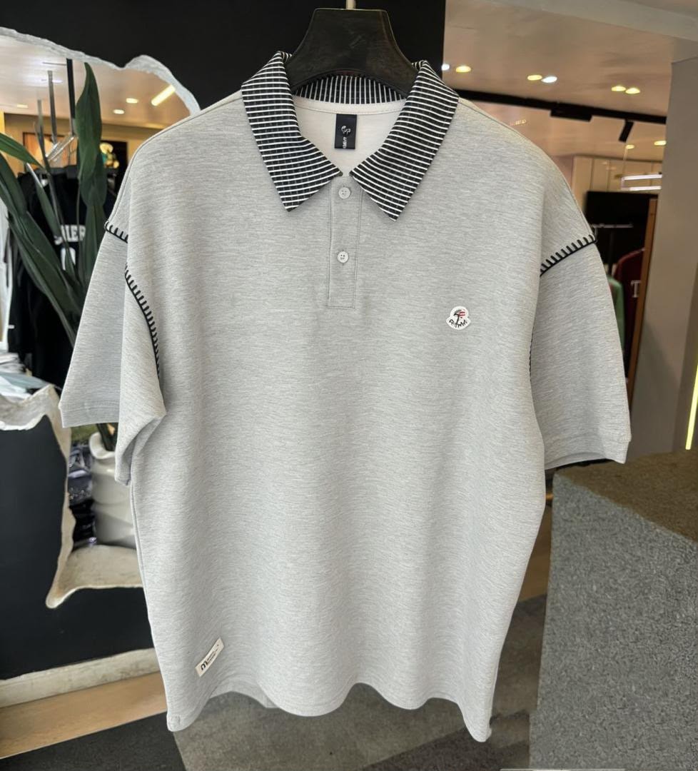 Light gray polo shirt on hanger in retail setting, showing full front with striped collar.