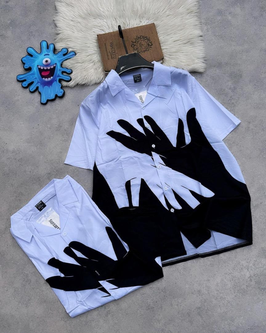 Light blue short sleeve shirt with large black hand prints.