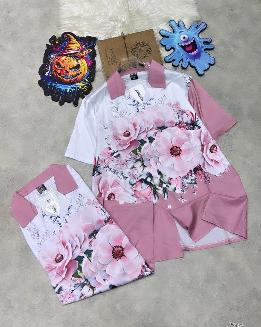 Short sleeve white shirt with large pink floral prints and pink collar accents.