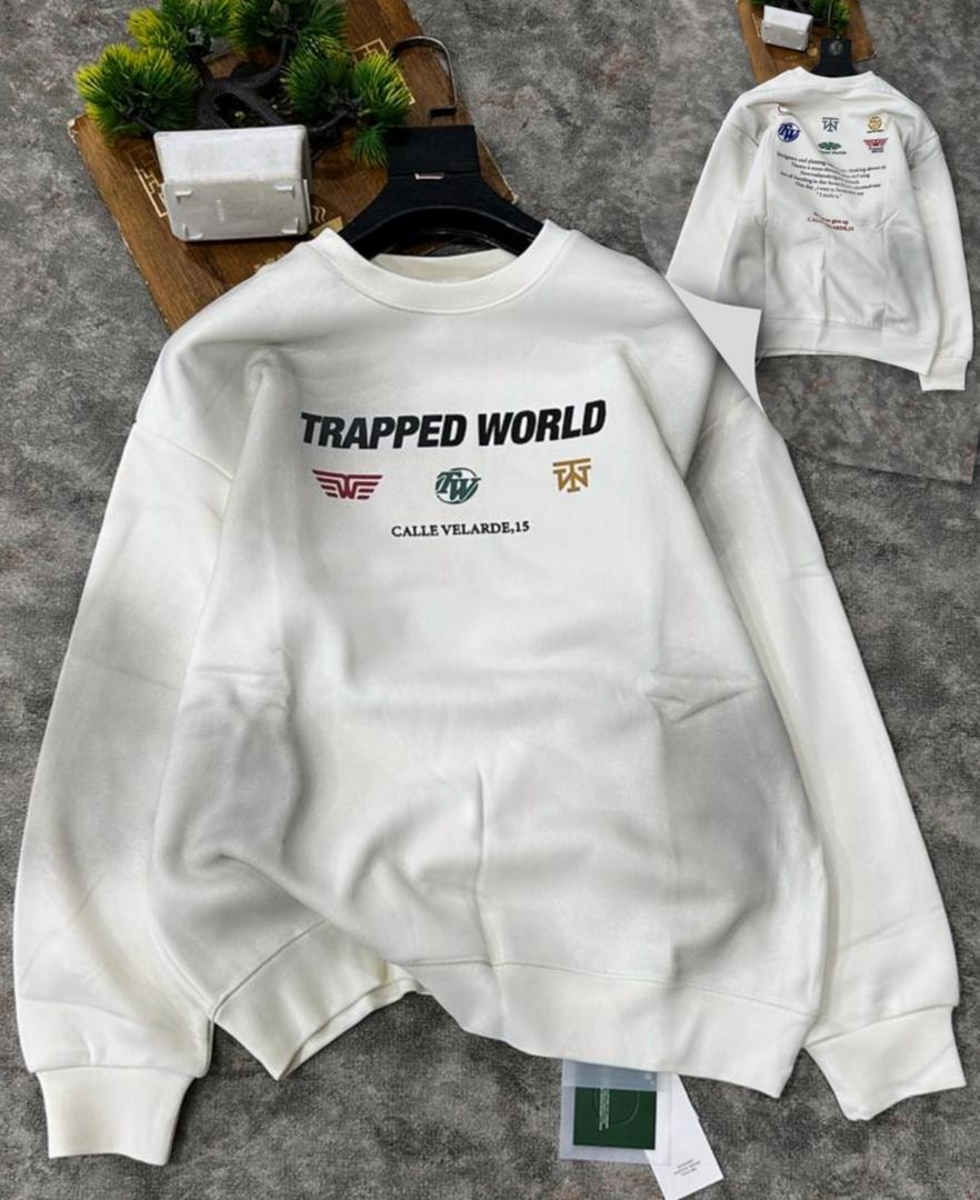 White sweatshirt showing front with Trapped World graphic, logos, and text plus inset back view with additional prints.