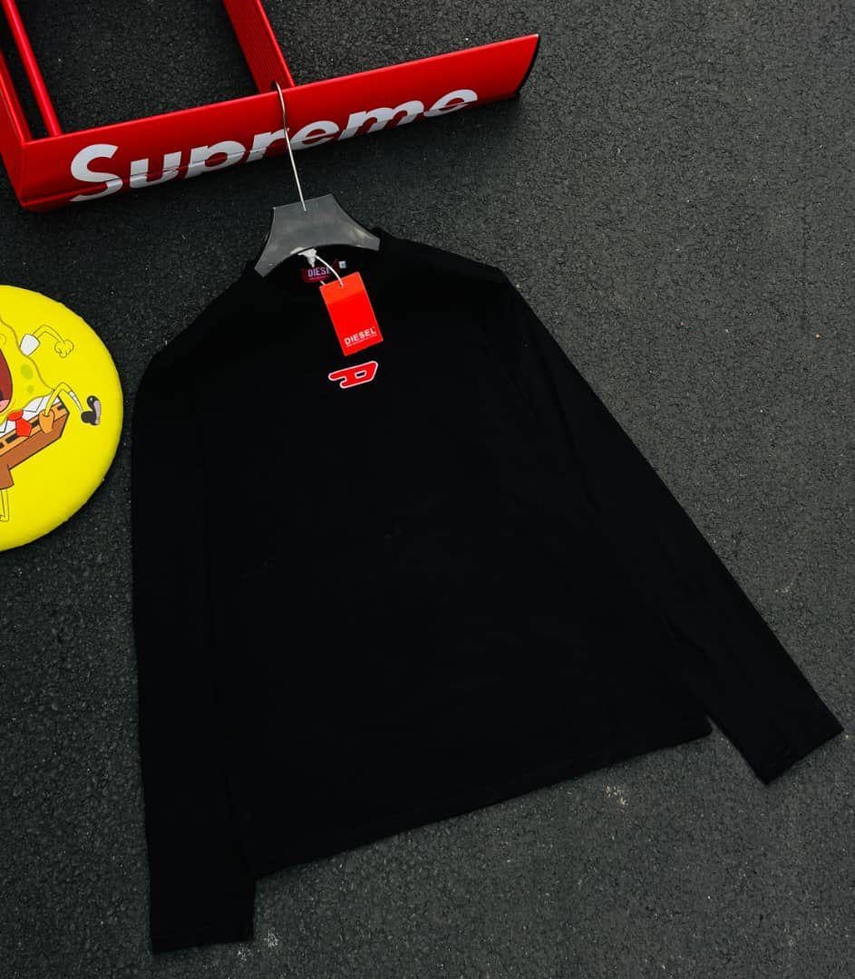 Black Diesel long sleeve t-shirt with red D logo and Diesel tag, displayed on hanger.