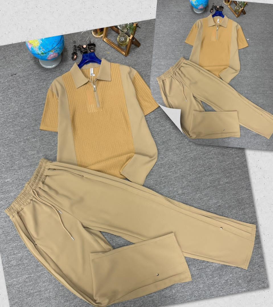 Yellow perforated zip polo shirt and matching trousers on gray surface with inset view.