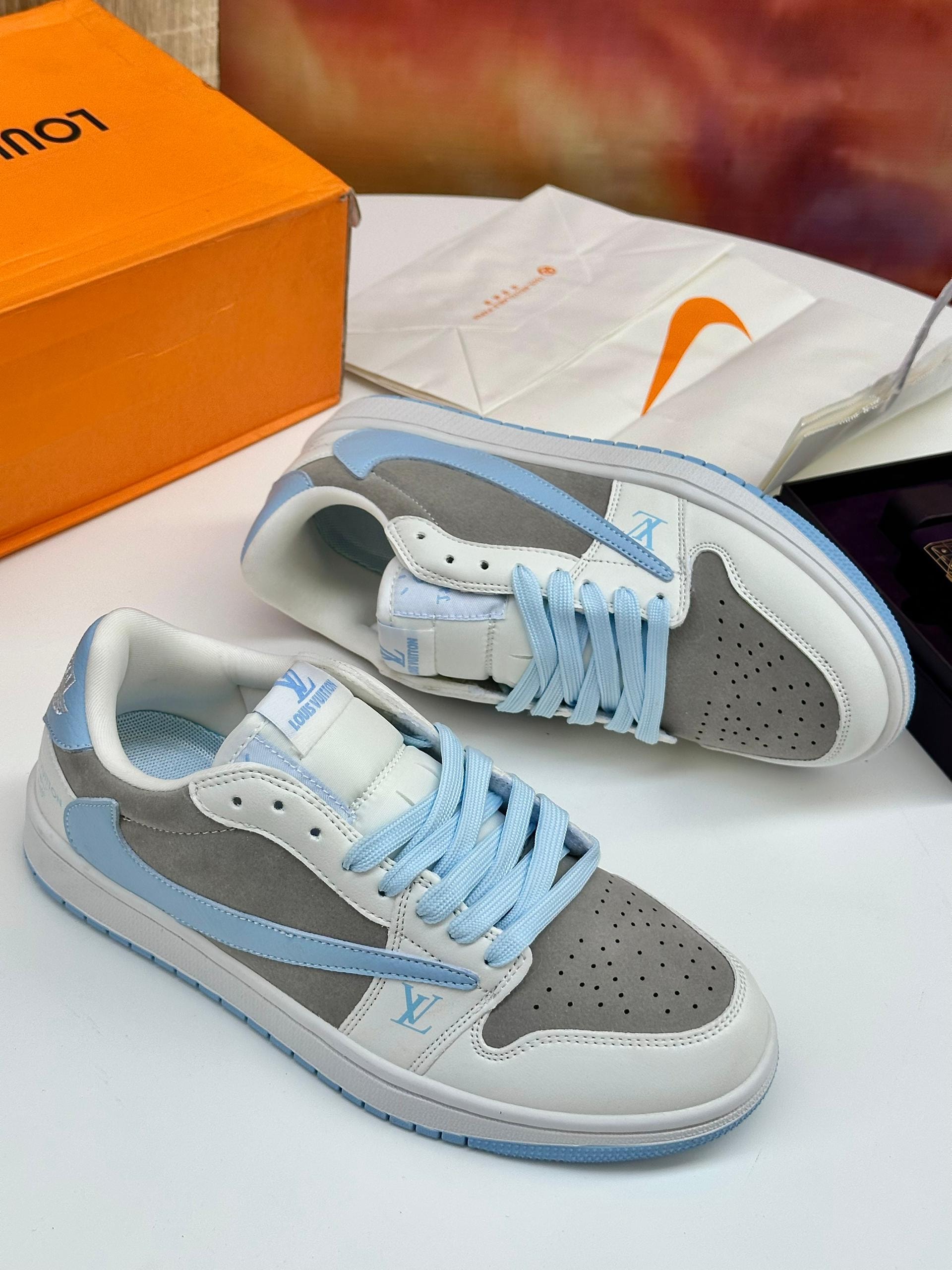 Gray white and blue Louis Vuitton Nike sneakers with orange box and dust bag.