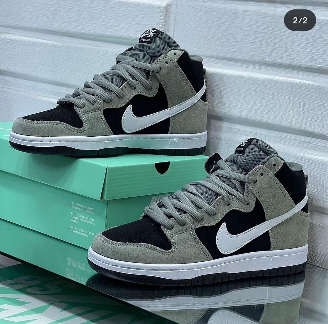 Nike Dunk High sneakers in black, gray and white with green Nike box.