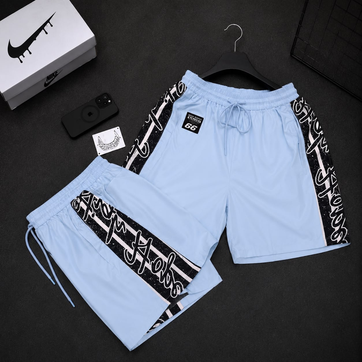 Light blue graffiti print cargo shorts with side stripes and High Hopes patch.