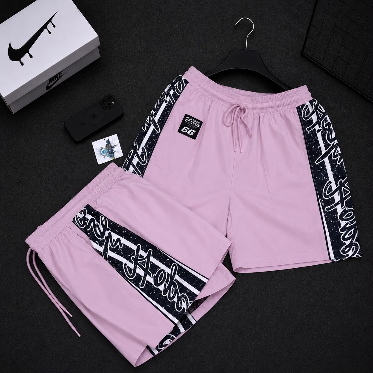 Pink graffiti print cargo shorts with side stripes and High Hopes patch.