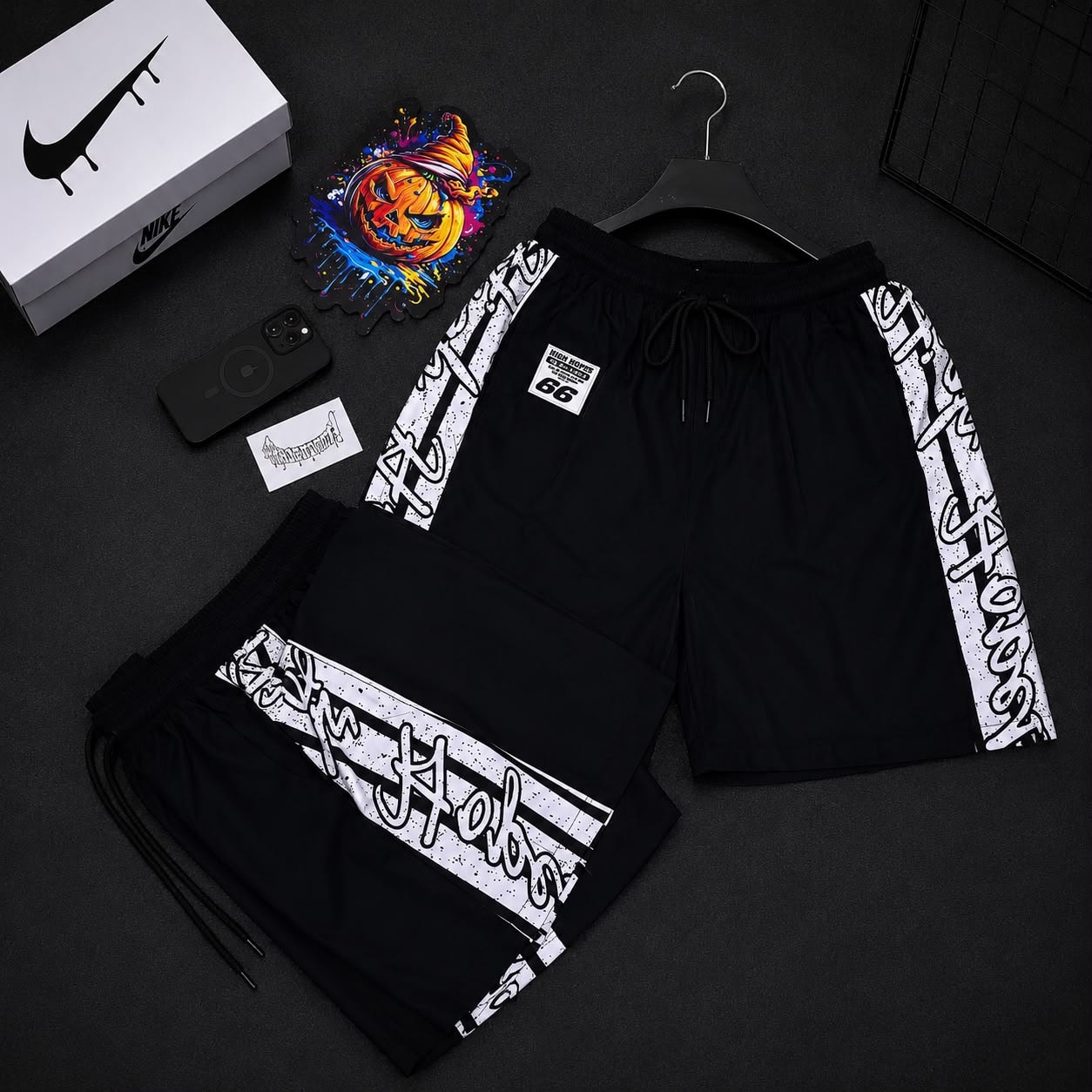 Black graffiti print cargo shorts with side stripes and High Hopes patch.