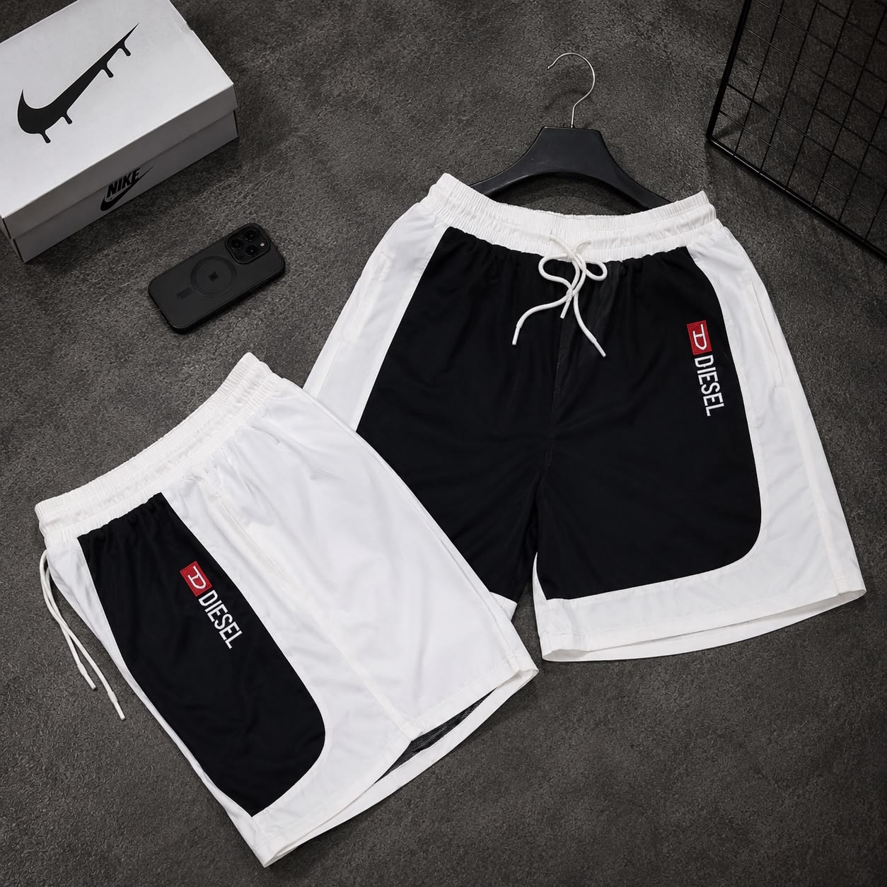 White and black colorblock cargo shorts with Diesel logo displayed in two variations.