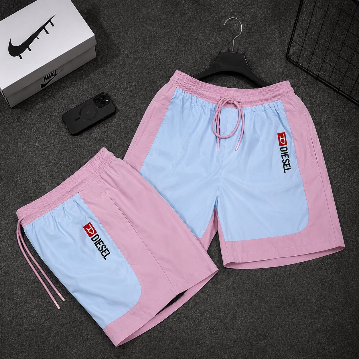Pink and light blue colorblock cargo shorts with Diesel logo in two variations.