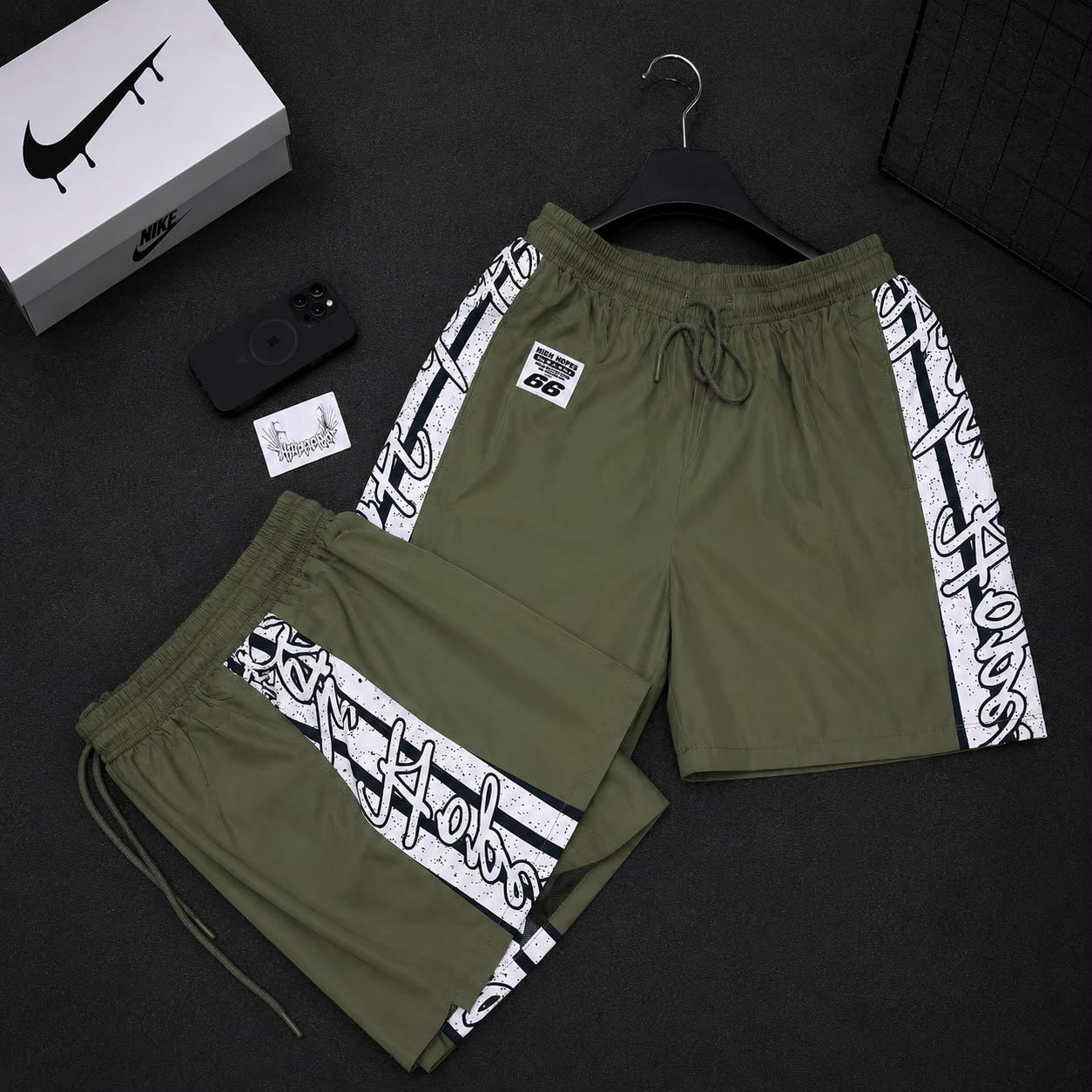 Olive green graffiti print cargo shorts with side stripes and High Hopes patch.