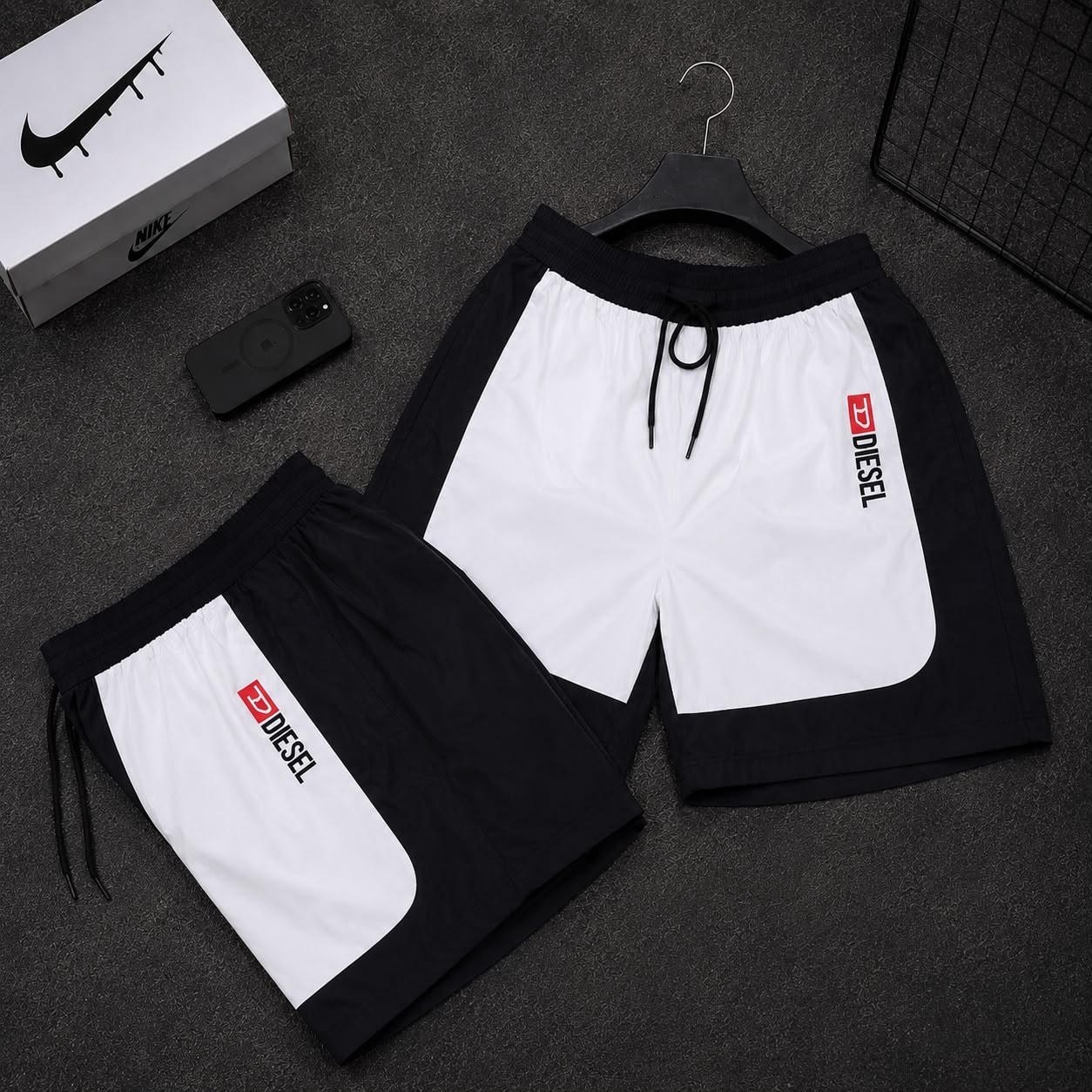 Black and white colorblock cargo shorts with Diesel logo displayed in two variations.