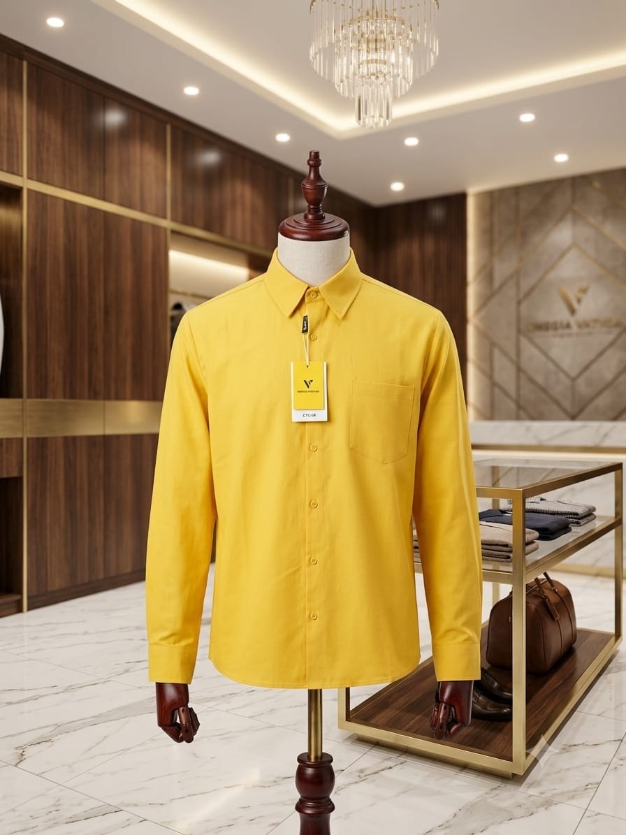 Yellow long sleeve button-down shirt on mannequin in luxury interior.