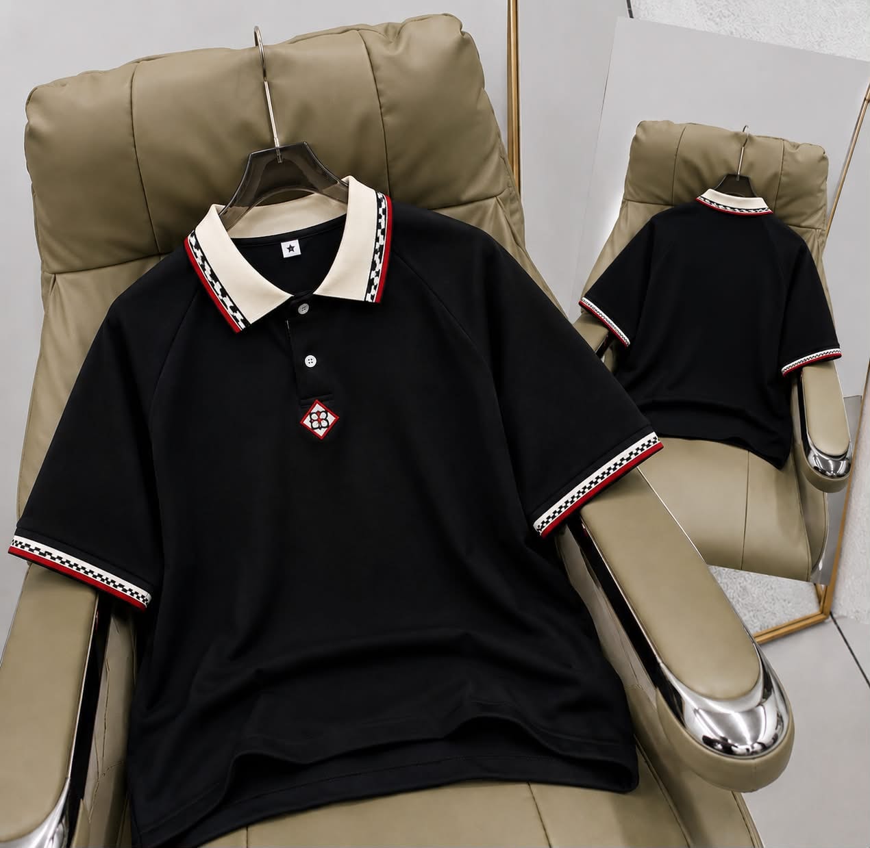 Black short sleeve polo shirt with patterned trim on collar and cuffs, front and back views.