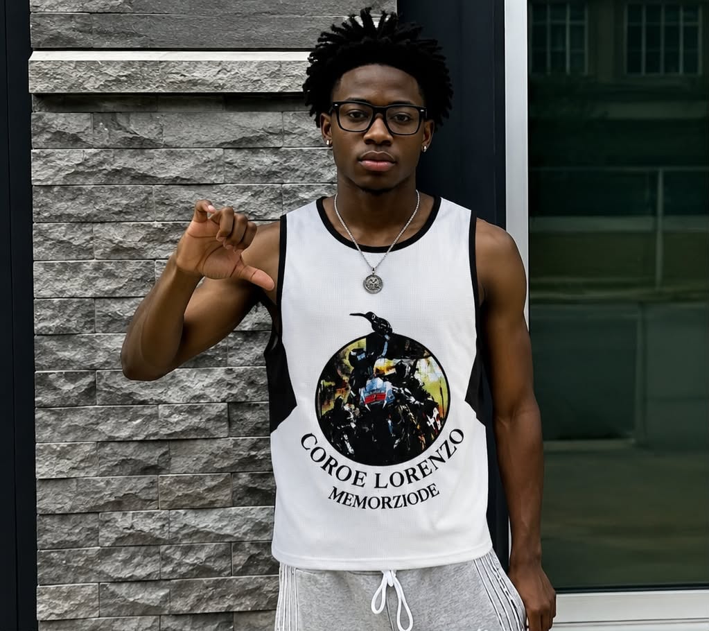 Man modeling white armless tank with black side panels and circular motorcycle graphic.