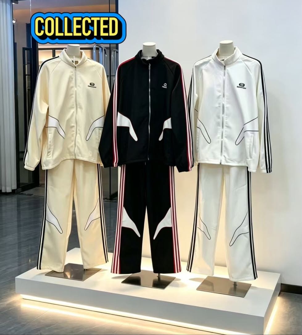 Three Balenciaga tracksuits on mannequins in cream, black, and white colorways.