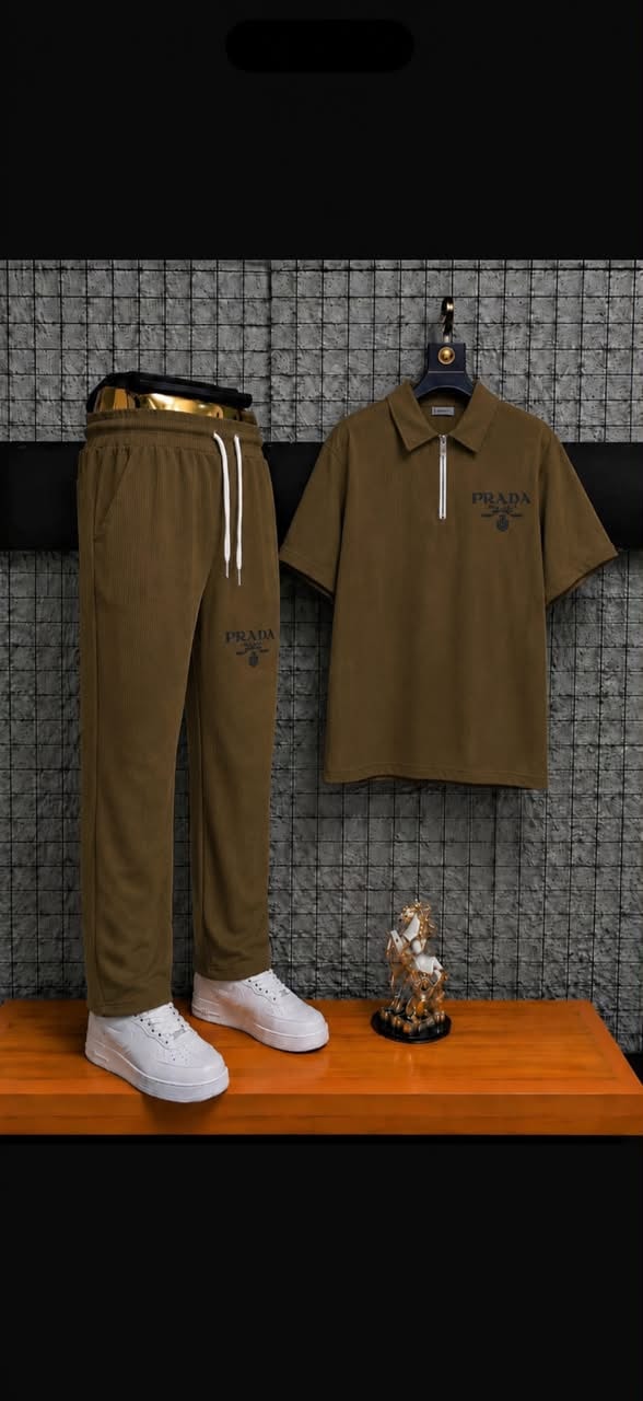 Brown ribbed polo and jogger two-piece set styled on wooden surface with accessories.
