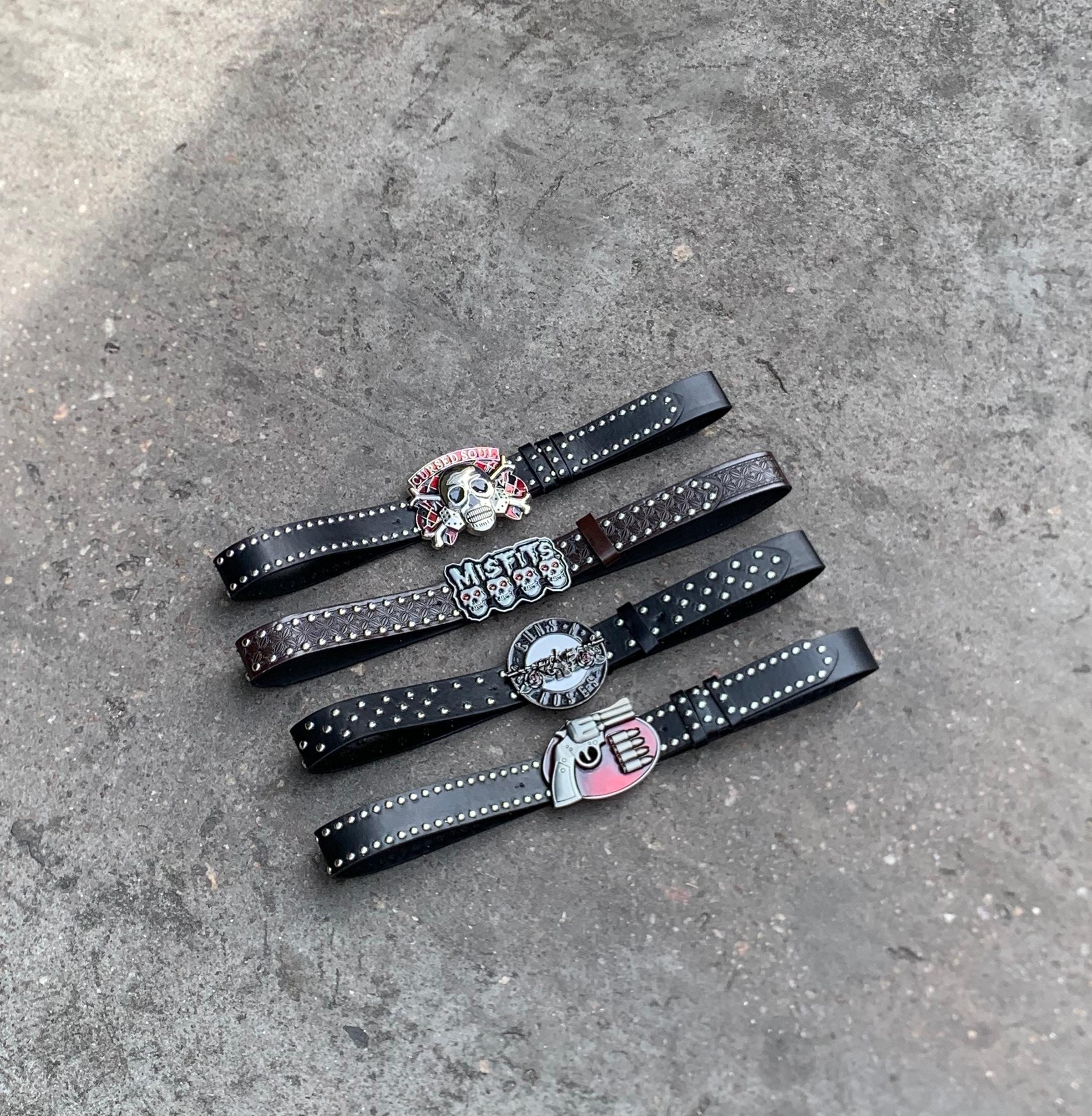Assorted punk belts with misfits guns n roses and revolver buckles.