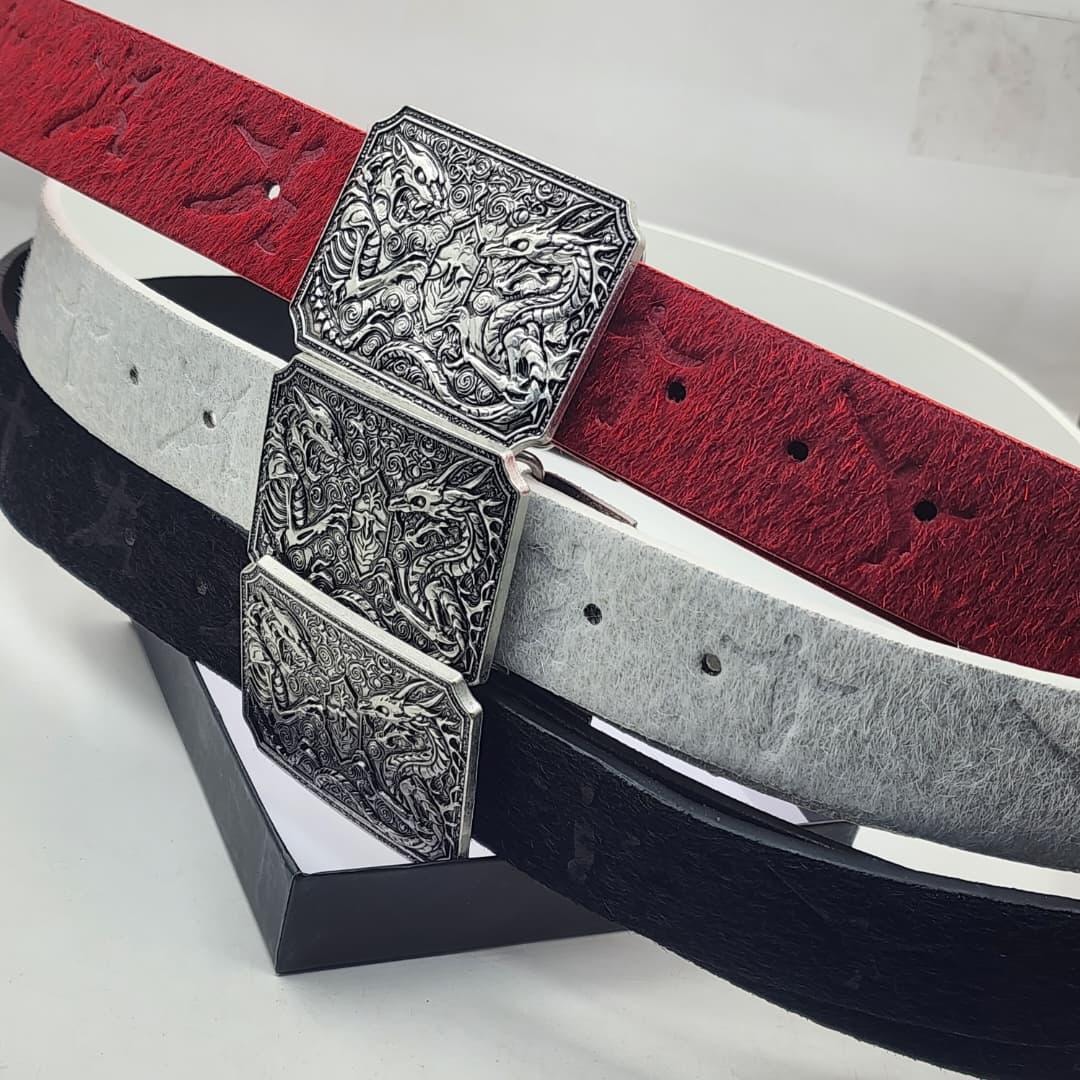 Three designer belts with dragon engraved buckles in red, white, and black colors.