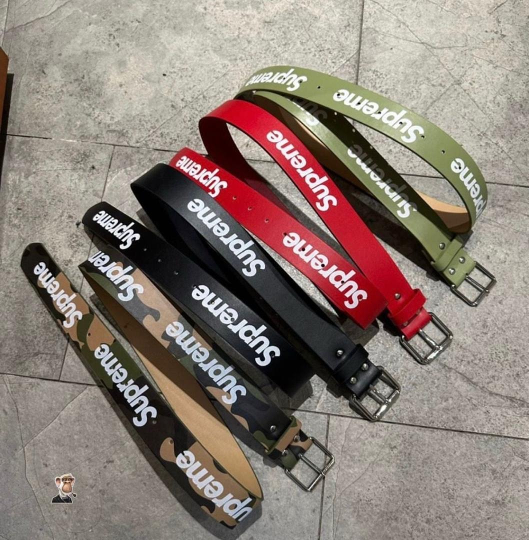 Supreme logo belts in camouflage, black, red, and olive green laid out together