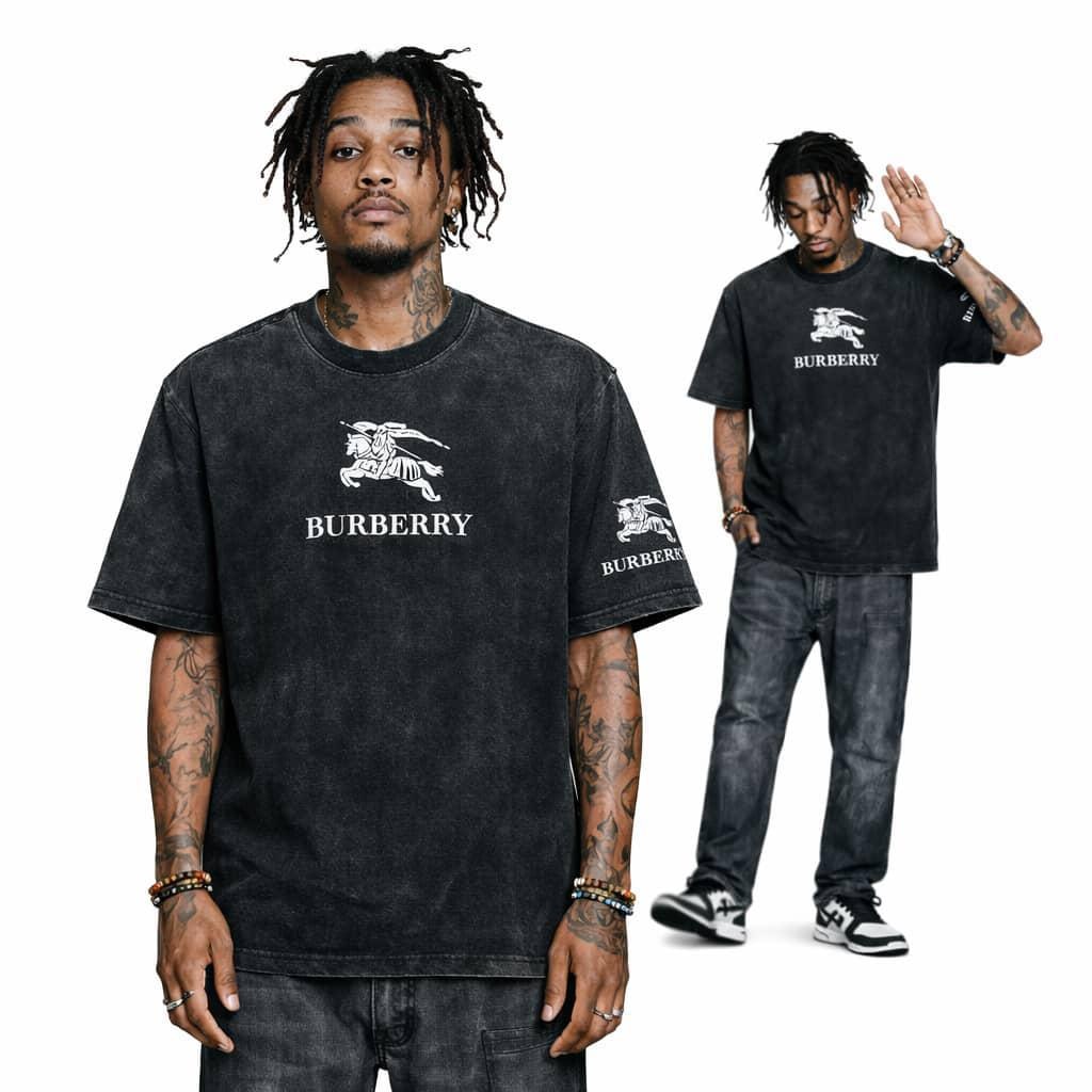Man modeling black stonewash Burberry graphic t-shirt with white logo on chest and sleeve.