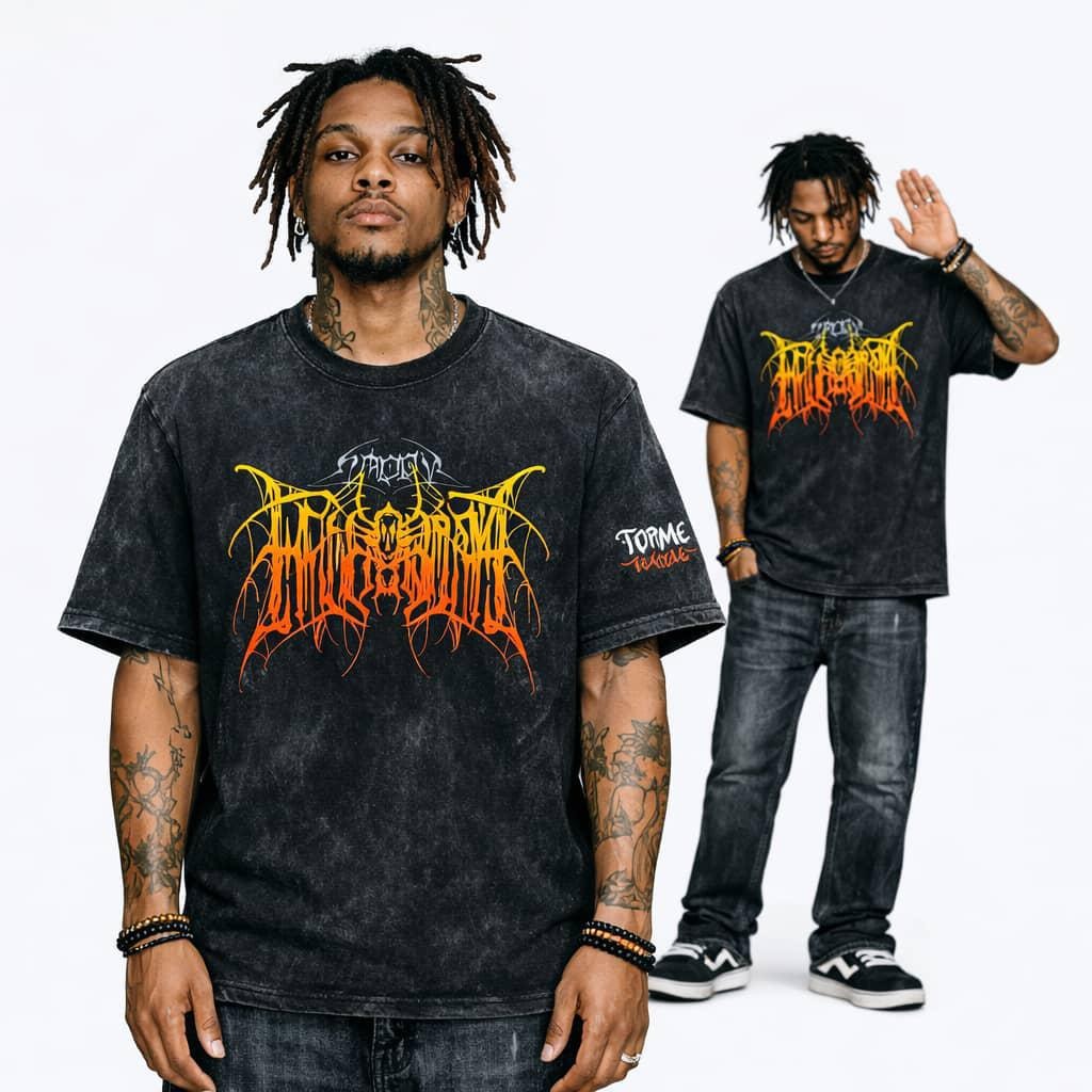 Man modeling black stonewash t-shirt with large yellow and orange graphic print on chest.