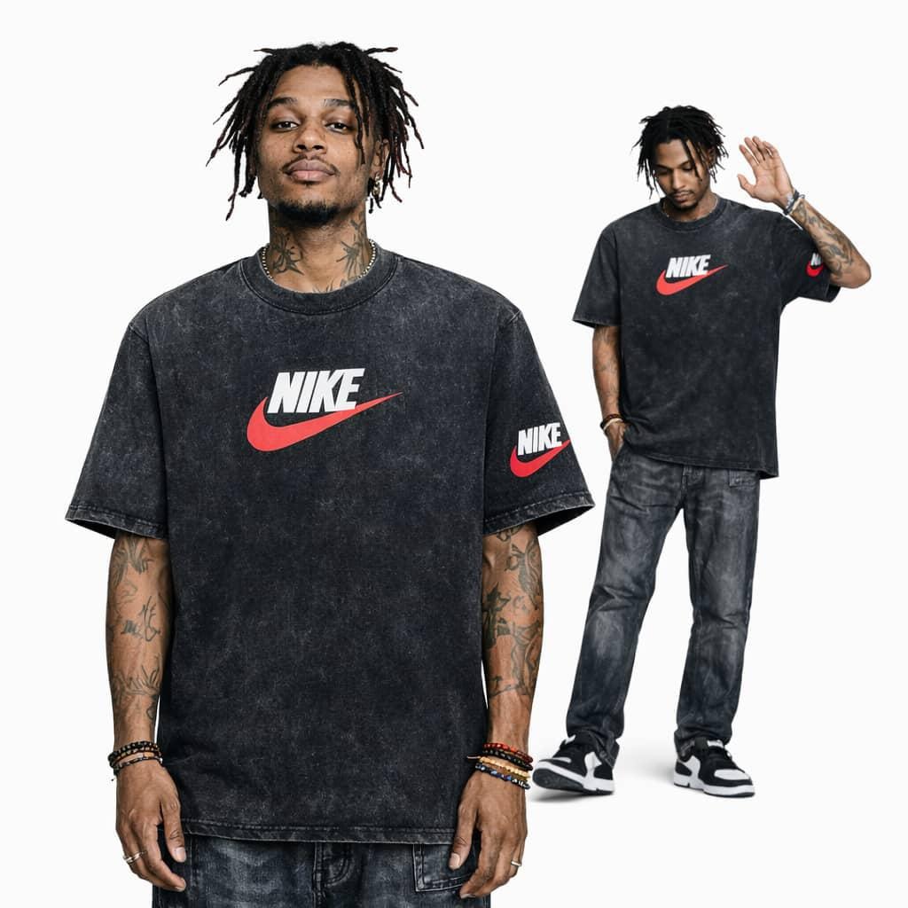 Man modeling black stonewash Nike graphic t-shirt with red swoosh on chest and sleeve.