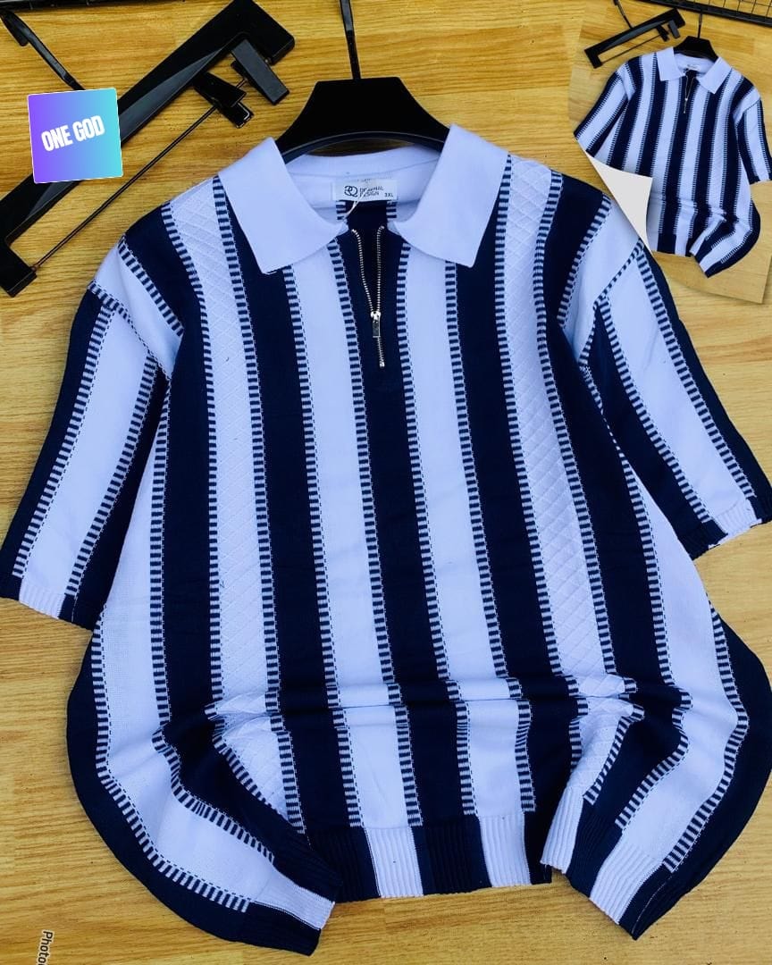 Navy and white striped knit quarter-zip polo on wooden surface.