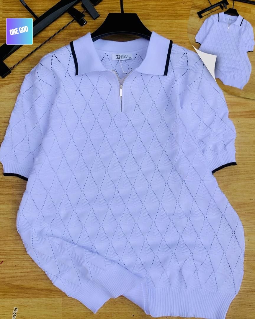 Light purple diamond knit quarter-zip polo with black trim on wooden background.
