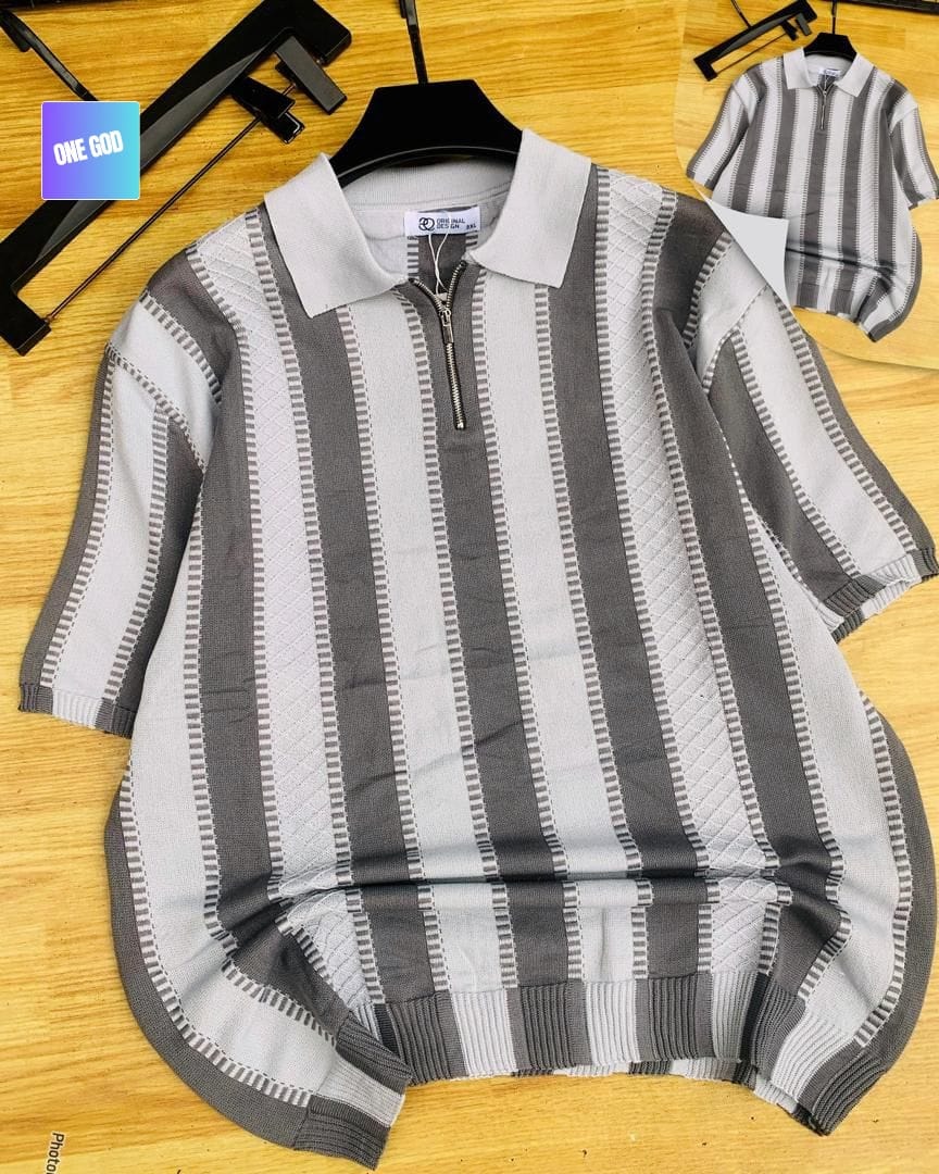 Gray and white striped knit quarter-zip polo on wooden surface.