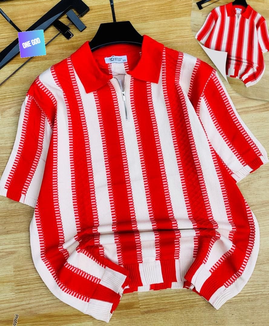 Red and white striped knit quarter-zip polo on wooden surface.