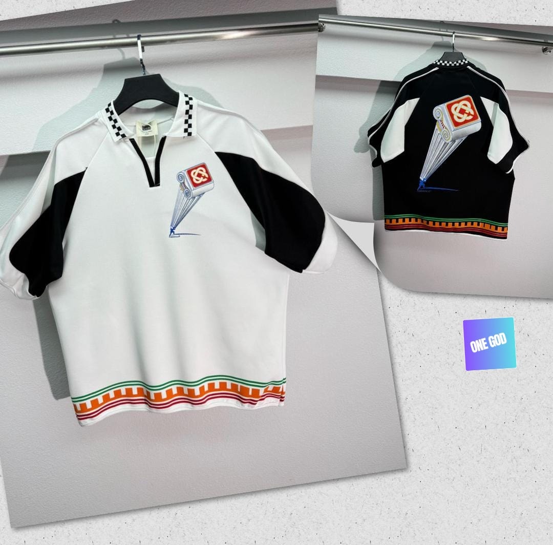 White and black colorblock polo with checkered collar and graphic.