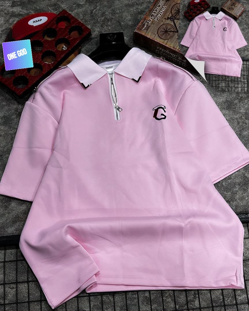 Pink polo shirt with quarter zip and G logo on chest.