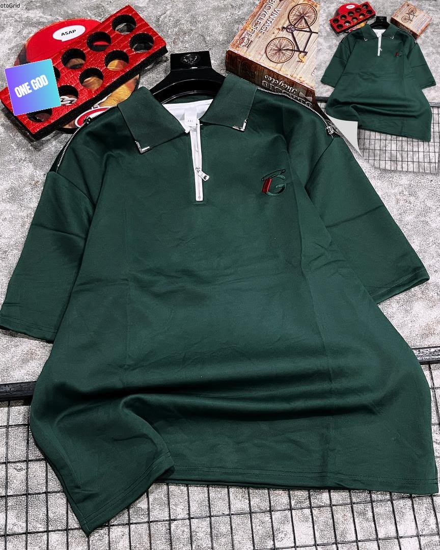 Dark green polo shirt with quarter zip and G logo on chest.