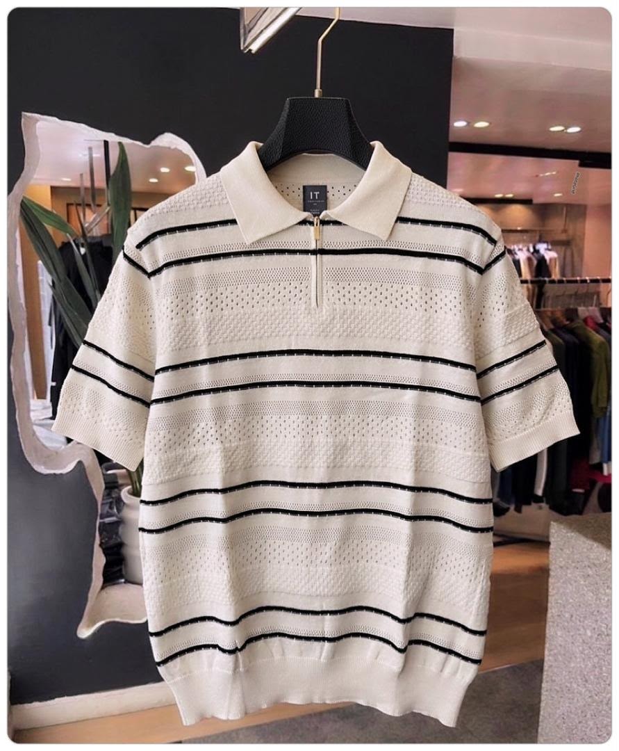 Cream with black stripes quarter-zip knit polo shirt on hanger in store.