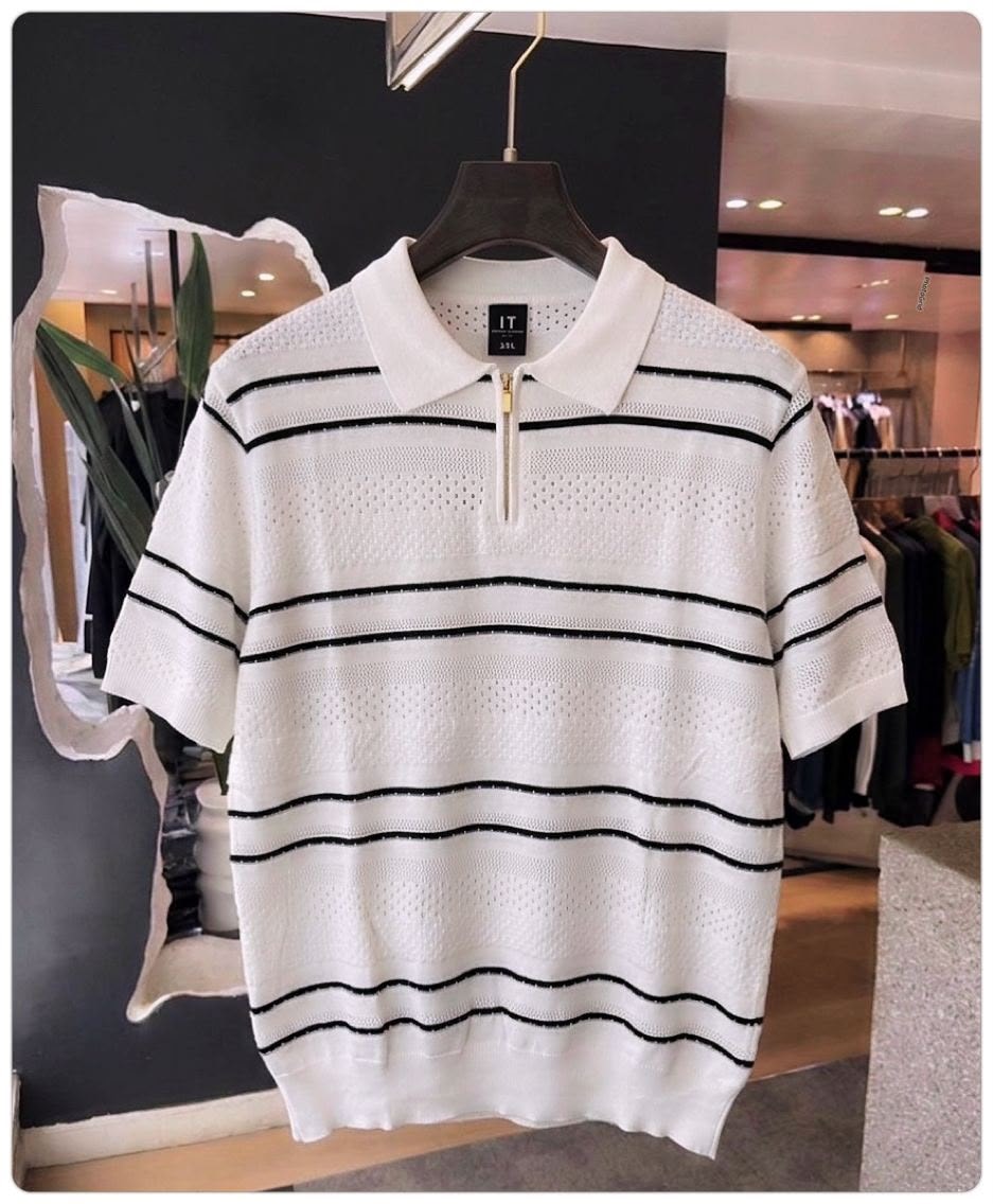 White with black stripes quarter-zip knit polo shirt on hanger in store.