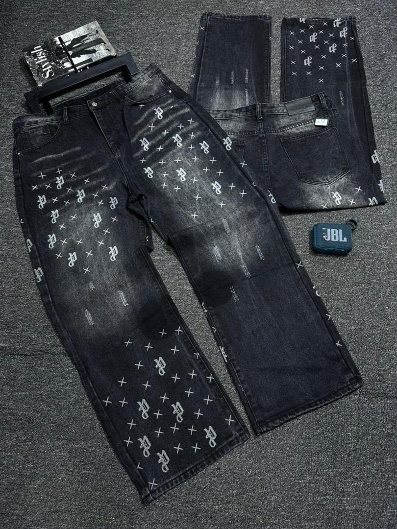 Black baggy jeans with white all-over prints shown in flat lay front and back views.