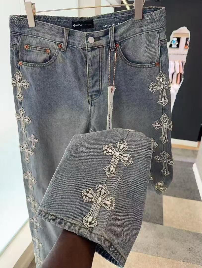 Light blue baggy jeans with large rhinestone crosses on hanger and close-up detail.