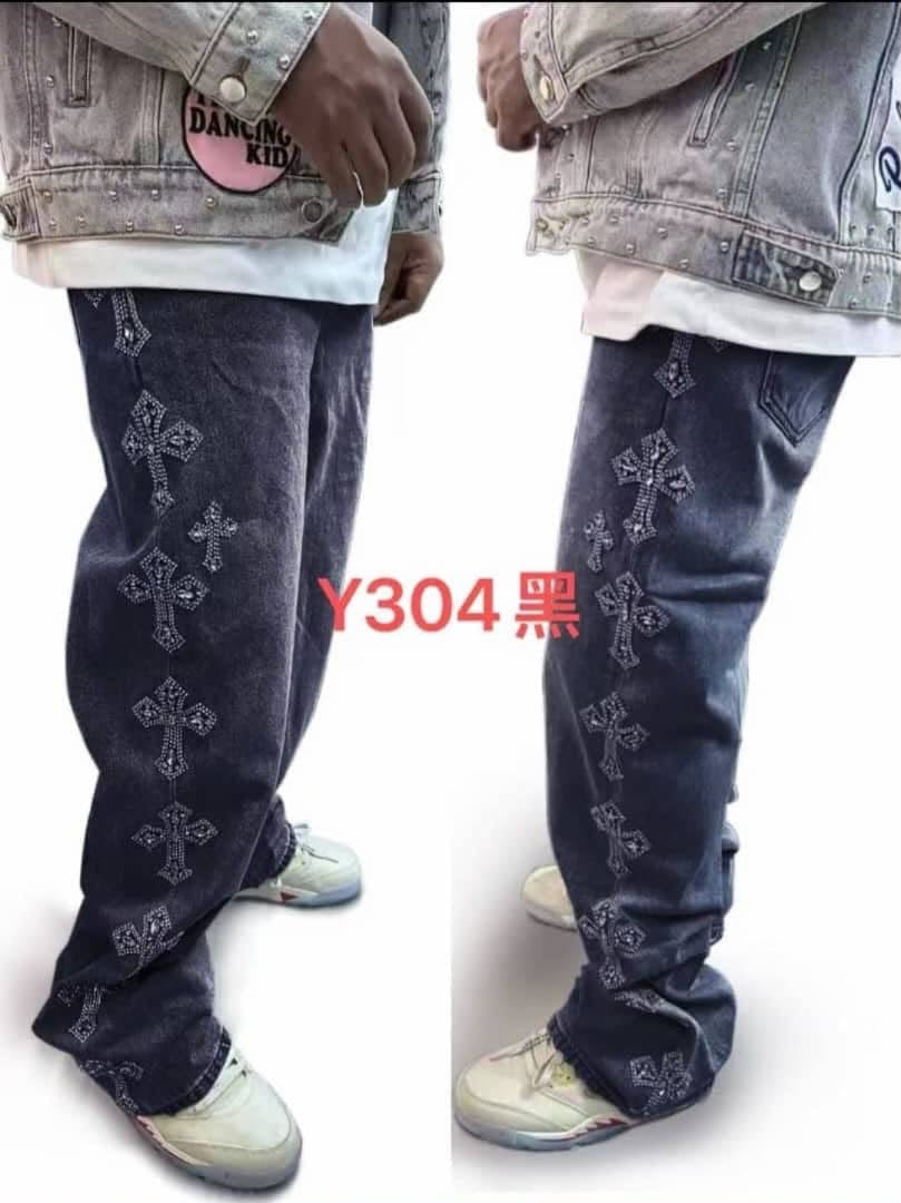 Model wearing black baggy jeans with rhinestone cross patterns, side and front views.