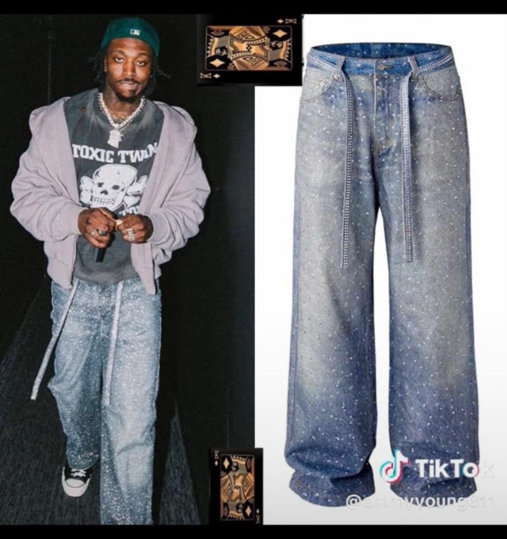 Flat lay of light blue baggy jeans showing white splatter pattern and vertical lines.