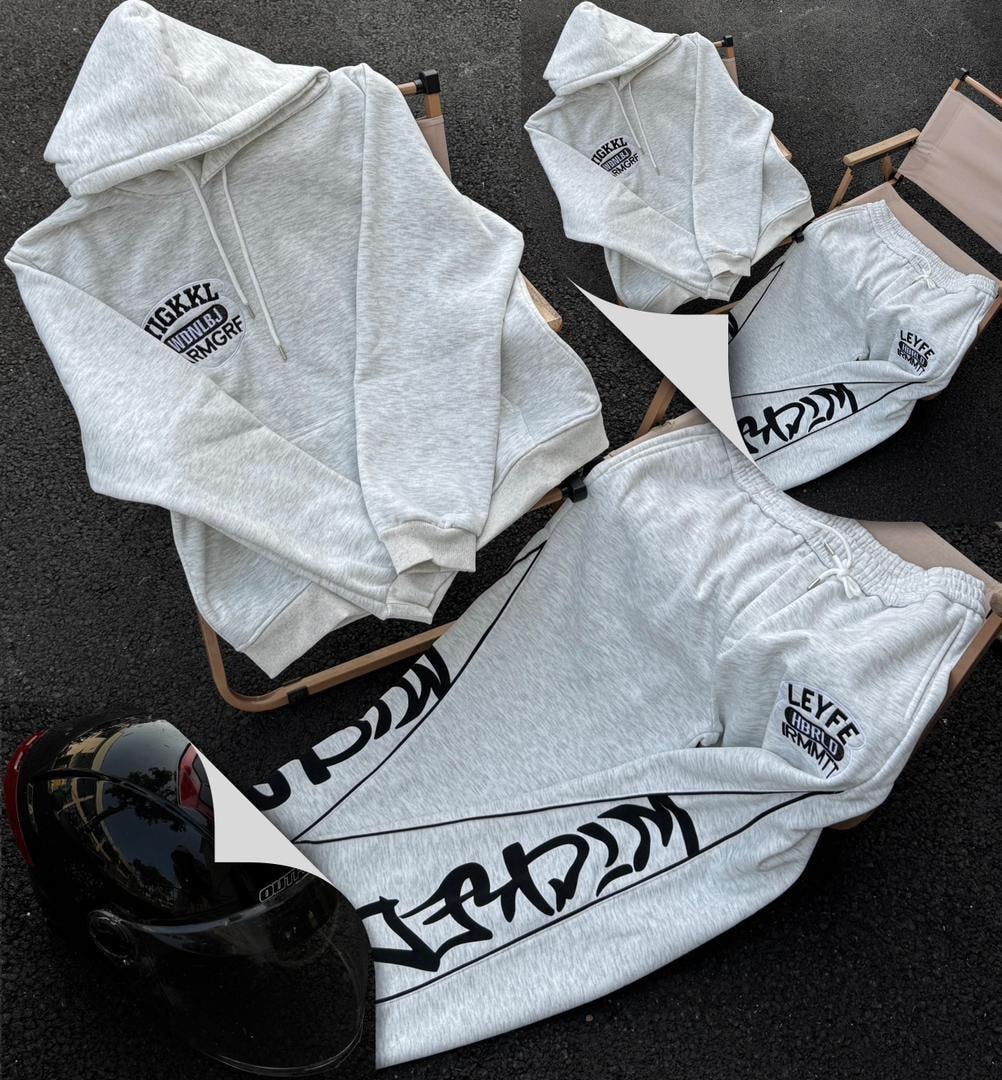 Light gray hooded two-piece set with graphic prints laid out on director chairs.