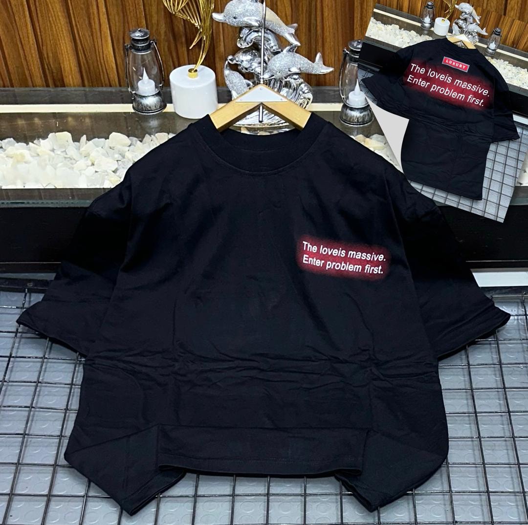 Black oversized t-shirt with red gradient chest text 'The loveis massive. Enter problem first.' and back view inset.