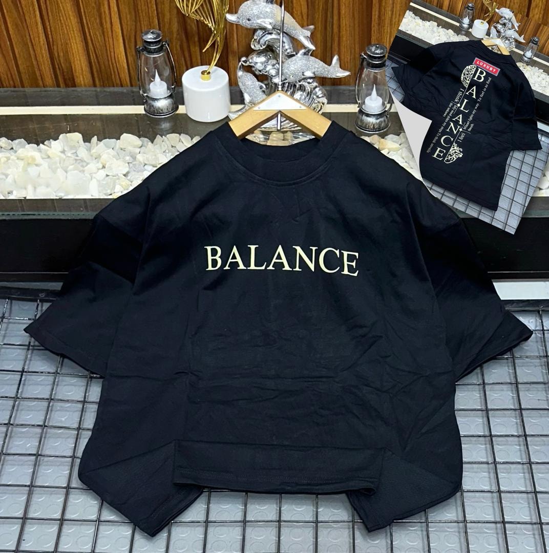 Black oversized t-shirt with gold 'BALANCE' chest print and back view with vertical text inset.