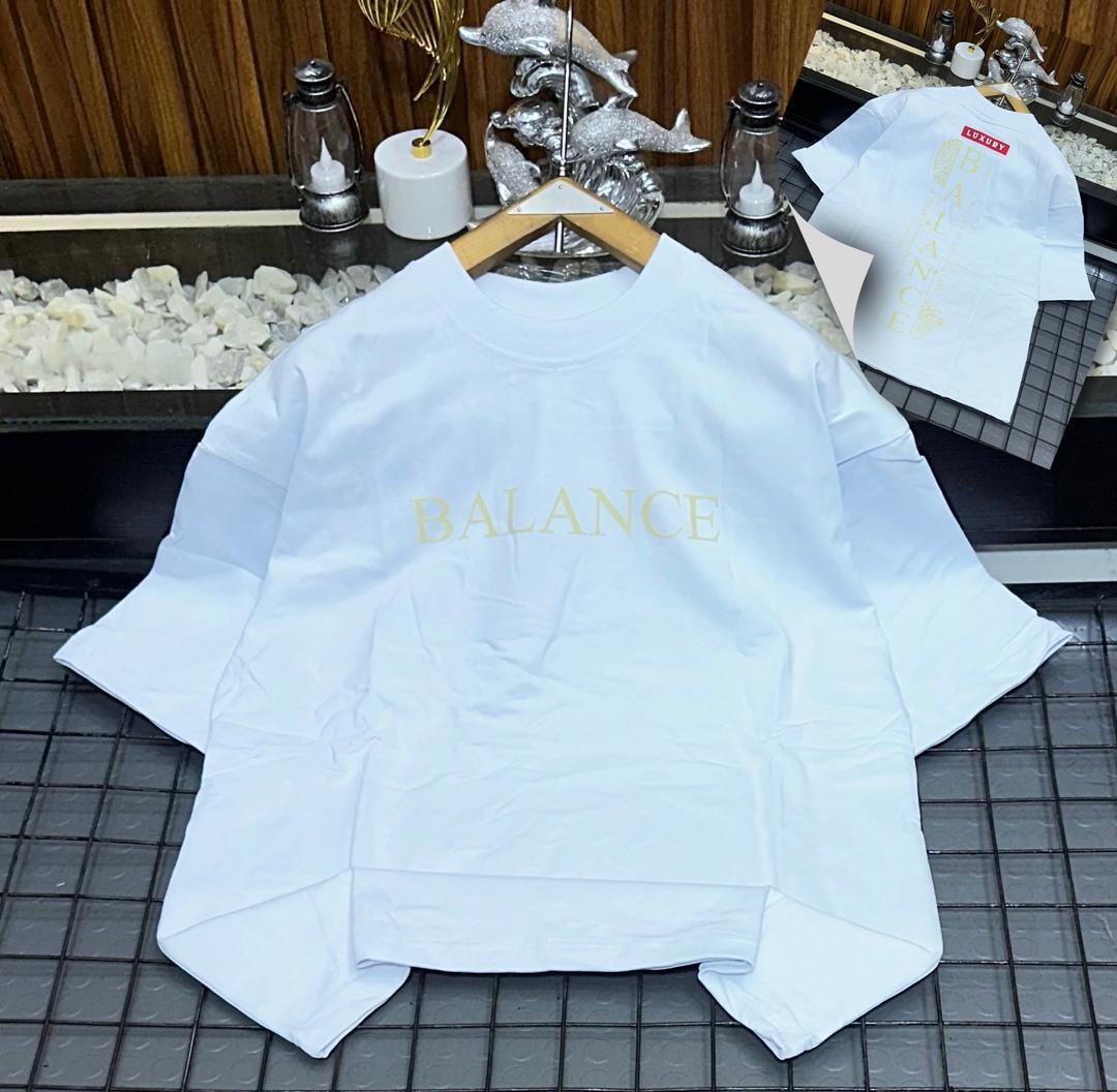 White oversized t-shirt with gold 'BALANCE' chest print and back view with vertical text inset.