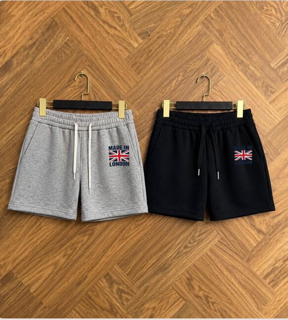 Gray and black fleece shorts with Made in London Union Jack embroidery shown side by side on hangers.