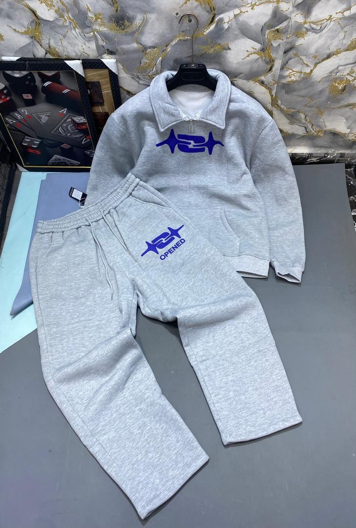 Gray quarter-zip hoodie and joggers with blue symbol logo.